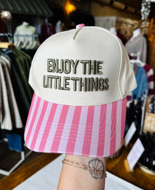 Enjoy The Little Things Trucker Hat - cream snapback hat with olive and mocha embroidered text and pink striped bill, front view