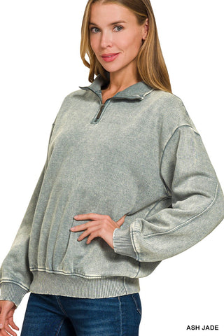 Woman wearing an ash jade green-grey acid wash fleece quarter zip sweatshirt.