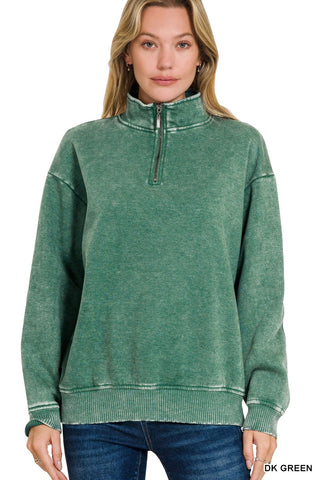 Model in a dark green acid wash pullover featuring a cozy fleece interior and zip neckline.