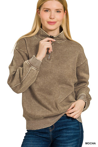 Model wearing a mocha brown acid wash sweatshirt with quarter zip and relaxed silhouette.