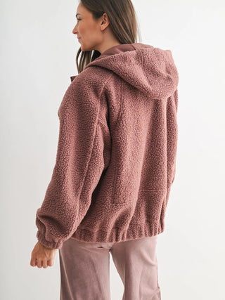 Back view of mauve sherpa hoodie showing hood and cozy texture.