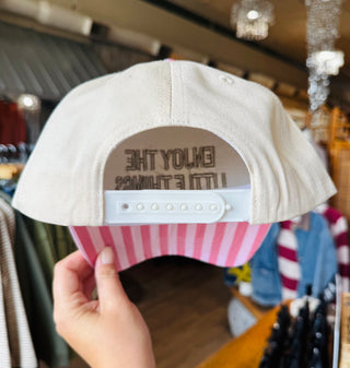 Enjoy The Little Things Trucker Hat - back view showing white adjustable snapback closure and pink striped underside of bill