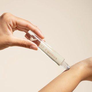 Photo showing how to use the rollerball against your wrist - Coast and Salt Amber Equinox perfume roller - cruelty-free luxury fragrance with night-blooming jasmine and golden musk
