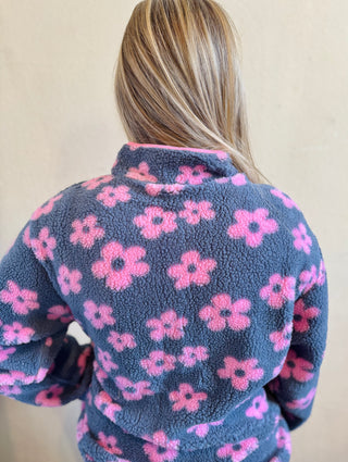 Back view of women's floral sherpa jacket featuring pink flowers on a slate blue background