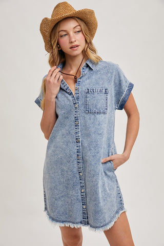 Model wearing a short-sleeve denim shirt dress with front button closure, chest pocket, and frayed hem — perfect for casual summer days or weekend getaways.