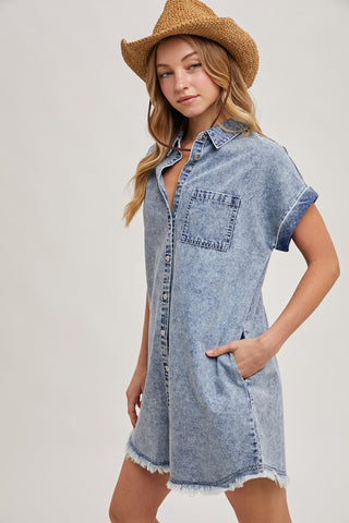 Model wearing a short-sleeve denim shirt dress with front button closure, chest pocket, and frayed hem — perfect for casual summer days or weekend getaways.