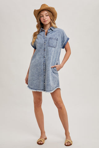 Model wearing a short-sleeve denim shirt dress with front button closure, chest pocket, and frayed hem — perfect for casual summer days or weekend getaways.