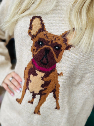 Close-up of knitted French Bulldog graphic on oatmeal sweater, showing detailed dog design and texture.
