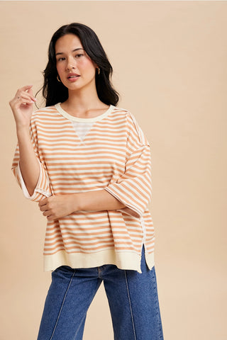 Front view of peach striped French terry short sleeve pullover top with relaxed oversized fit.