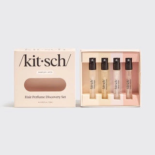 Cream colored Kitsch Hair Perfume Discovery Set box shown besides four sample-sized fragrance vials in a blush-toned tray.