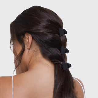 Woman wearing x-small claw clips in half-up hairstyle