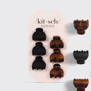 Set of six x-small black and tortoise claw hair clips on neutral background