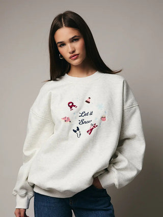 Front view of the Let It Snow Sweatshirt in light grey featuring embroidered holiday design. 