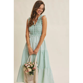 Woman in Kelly Green striped smocked midi dress - styled look