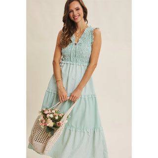 Woman wearing Kelly Green striped midi dress with smocked bodice and tie detai