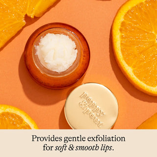 Orange blossom lip scrub with citrus ingredients on orange background