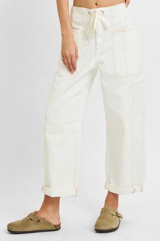Front angle view of cream drawstring barrel jeans with large patch pockets