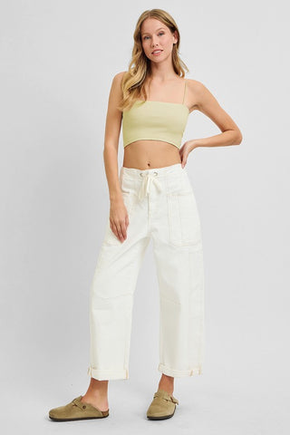 Full body view styled with a cropped tank top and neutral slides