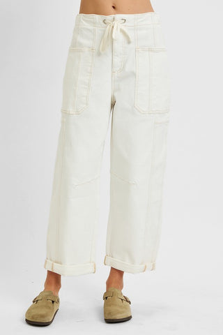 Front angle view of cream drawstring barrel jeans with large patch pockets