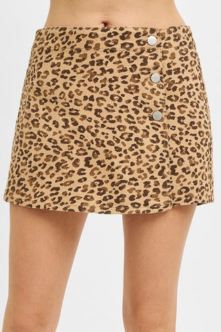 Tan and brown leopard print skort with silver button details down the side and a subtle wrap-style front; high-waisted fit.