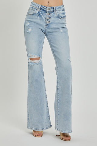 Front angled view of Risen light wash flare jeans with button fly and ripped knee detail