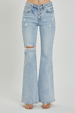 Full front view of light wash Risen flare jeans styled with heels