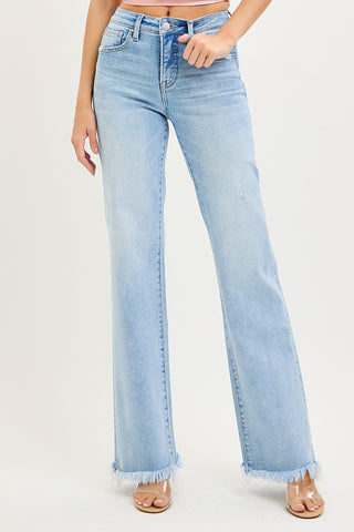 Close-up of raw hem detail on light wash straight leg denim.