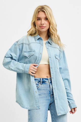 Mid-action shot of a relaxed fit denim button-up shirt worn open over a cream ribbed crop top — perfect for layering and everyday wear.