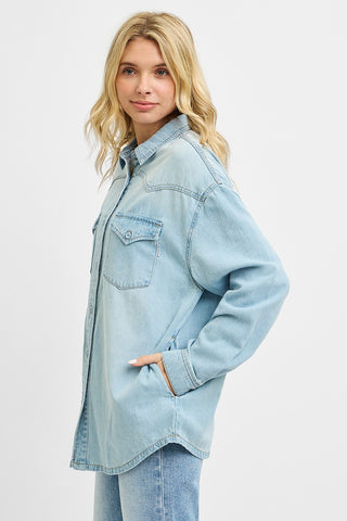 Side view of a western-style denim shirt with chest pockets and side hand pocket, styled casually for a laid-back look.