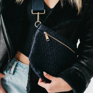 Woman wearing the Navy Westlyn Suede Bum Bag crossbody style and showcasing the woven suede texture and gold hardware