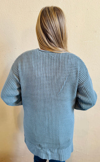 Back view of the blue grey waffle knit cardigan highlighting soft texture and longer length