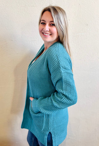 Side view of the dusty teal waffle knit cardigan showing relaxed fit and texture throughout
