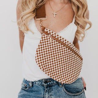 Close-up of the tan and ivory checkered Westlyn bum bag with gold zipper and clip hardware.