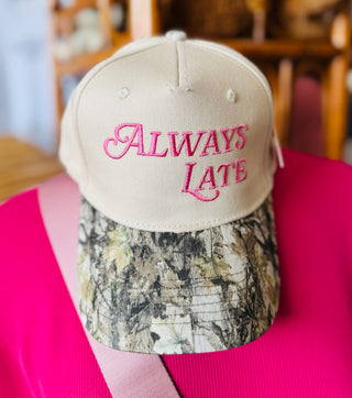 Always Late embroidered camo trucker hat in pink, taupe and camo colorway with structured 5-panel front and snapback closure