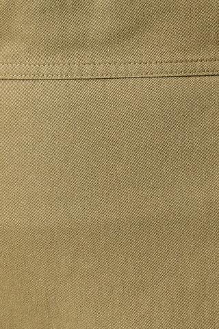Close-up of the skirt fabric/color with a horizontal stitched seam. Shows the twill/cotton fabric and light olive green color.