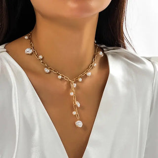 Close-up of lustrous pearl stations on delicate gold chain Y-necklace showing bohemian elegance