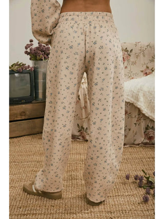 Back view of ditsy floral print fabric and drawstring elastic waistband on taupe lounge pants