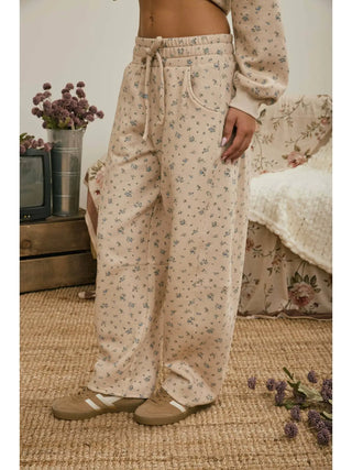 Side view of wide barrel leg lounge pants in taupe ditsy floral print with side pocket detail