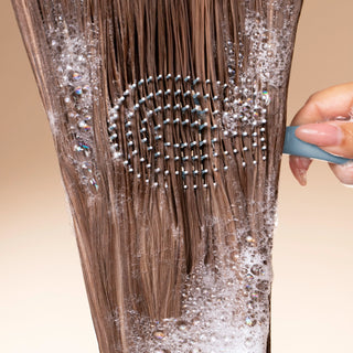 Haze Blue mini detangling brush showing bendable bristle design for gentle hair detangling