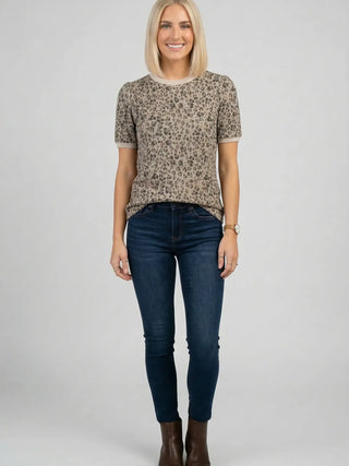 Model wearing mocha leopard print stretch knit top with short sleeves and round neckline, full front view on grey background
