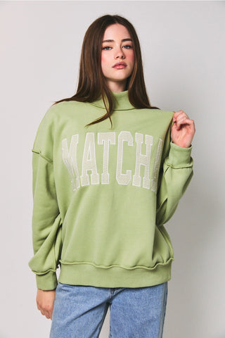 atcha Embroidered Mock Neck Sweatshirt in light matcha green – oversized boho pullover with Matcha polka dot embroidery, front view on model