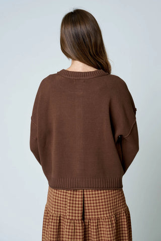 Back view of women's brown cotton blend knit cardigan sweater with drop shoulder silhouette and ribbed hem detail