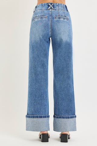 Back view of Risen high rise cuffed wide leg jeans – showing X cross belt loop, pleated waist detail, double welt flapless back pockets, and wide cuffed hem