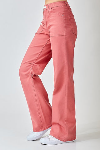 Side view of the Risen pair of high-waisted, wide straight-leg jeans in a brick color, featuring a front pork chop pocket detail.