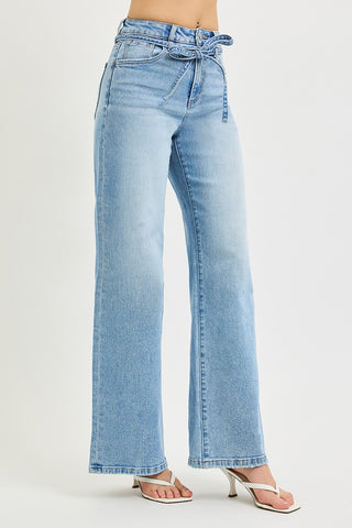 Three-quarter front view of Risen high rise wide leg jeans – light wash with tie waist string detail and wide leg cut