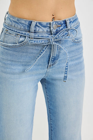 Close-up of Risen high rise wide leg jeans tie waist string detail – light wash denim showing denim bow tie threaded through belt loops