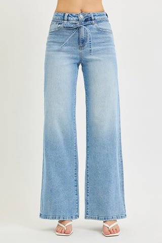 Risen high rise wide leg jeans with tie waist string detail – front view showing light wash denim, tie waist knot, and slanted front pockets
