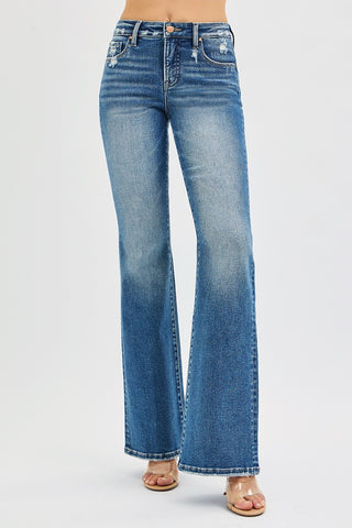 Risen Tummy Control High Rise Flare Jeans in dark wash – angled front view showing distressed waistband, lightened thigh, and flare leg