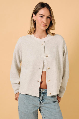 Round Neck Barrel Hem Knit Jacket in ash grey — model wearing open button-front knit cardigan with round neckline, styled with light wash wide-leg jeans