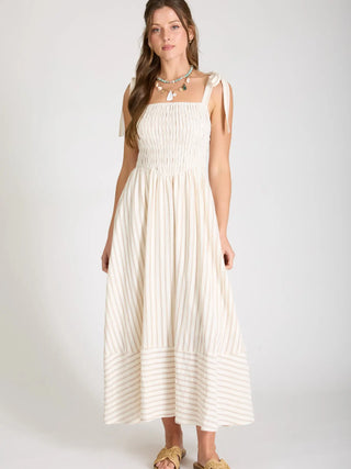 Woman wearing a midi length, basque waist, striped dress showing off the square neckline and midi length.
